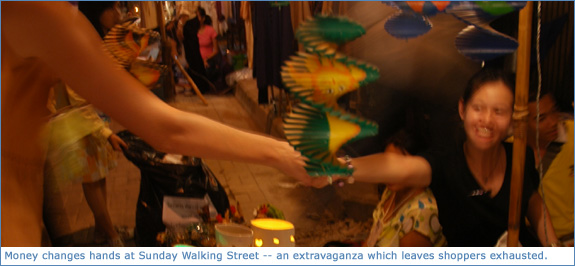 Money changing hands at the Chiang Mai walking market
