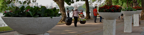 Vendor walking by the lake, Hanoi
