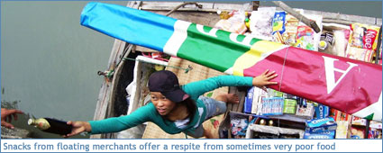 Snacks from floating vendors offer a respite from poor tour food on Ha Long Bay