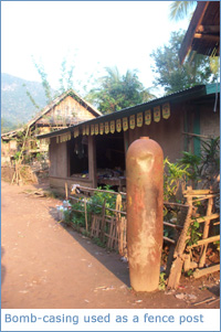 An old bomb casing being used as a fence post in Muang Ngoi