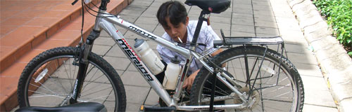 Bike shop repair guy, cigarette in hand Bike shop repair guy, cigarette in hand