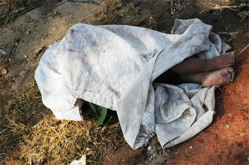 Dead child covered by the side of the road in Galle