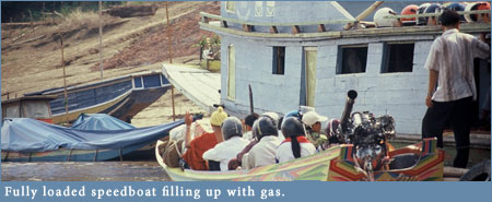 Speedboat gassing up on the Mekong River Speedboat gassing up on the Mekong River