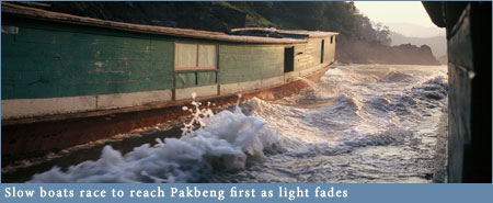 Slowboats racing into Pakbeng in fading light Slowboats racing into Pakbeng in fading light