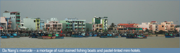 The riverside of Da Nang is a mix of fishing boats and pastel mini hotels