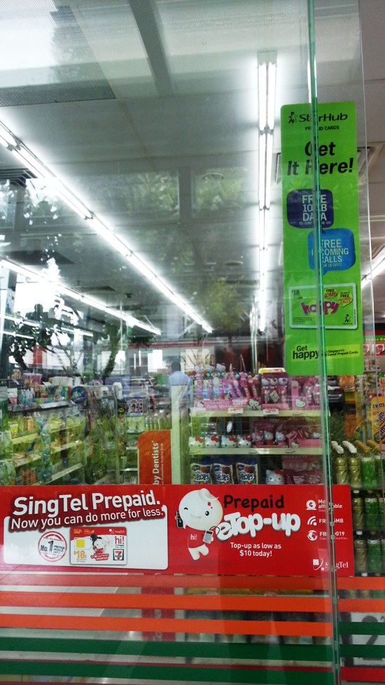 7-Eleven convenience stores sell prepaid mobile SIM cards.  This one sells SingTel and StarHub ones.