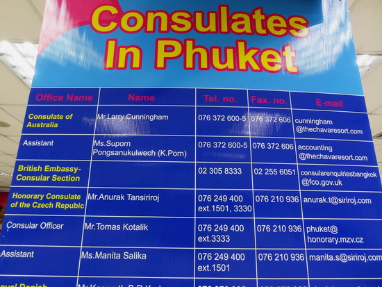 A list of consulates in Phuket seen at the airport baggage claim area.